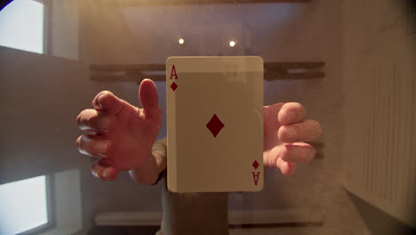 hand holding and fanning playing cards, ace of diamonds prominent