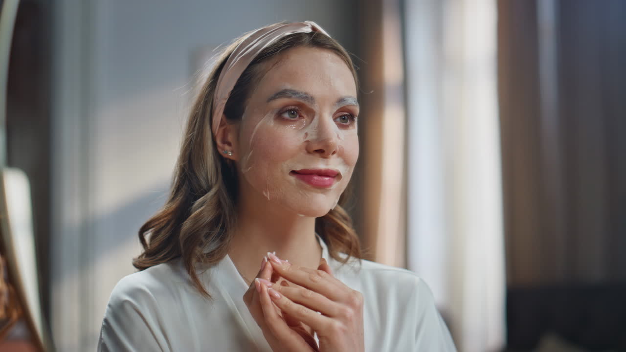 Woman applying a facial mask