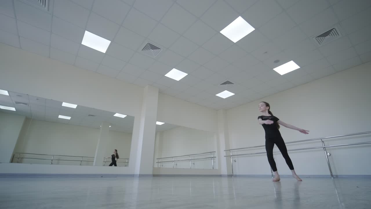 Young Ballerina Practicing Dance Moves in Studio
