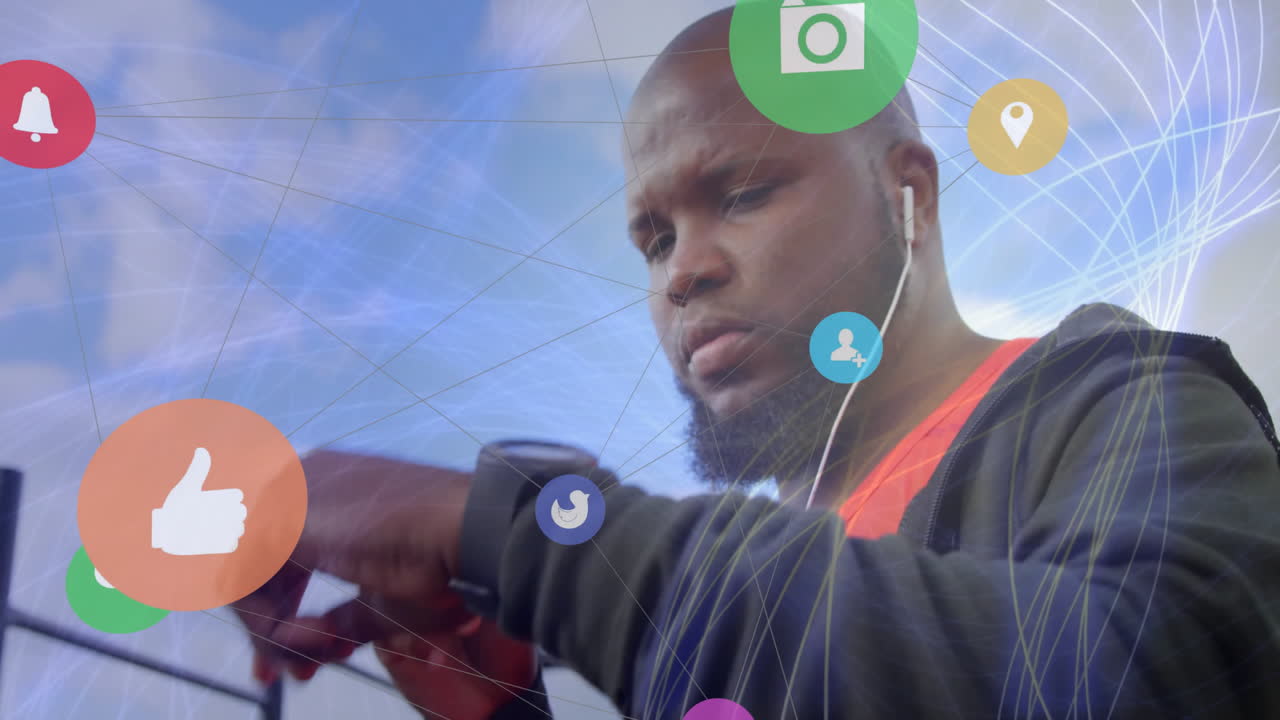 Man using smartwatch with social media icons animation over blue sky background