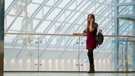 happy teenage girl holding bags with purchases, smiling while looking at phone in shopping center. received good news, reading message, texting. horizontal photo banner for website header design