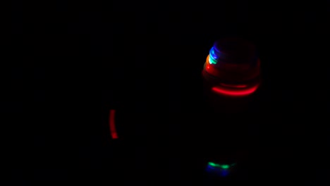 colorful bright light spinning and glowing over black backgroun