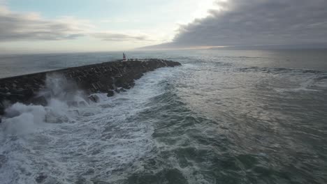 big stormy waves breaking against northern pier