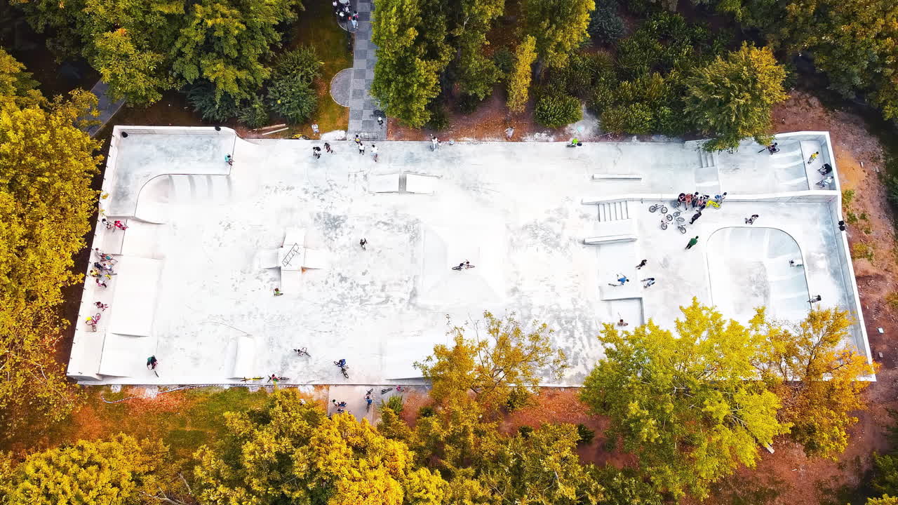 Aerial drone view of a skate park among autumn trees