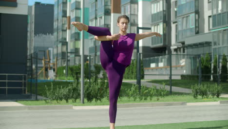 woman practicing yoga outdoors in an urban setting