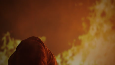 person shrouded in smoke and fire