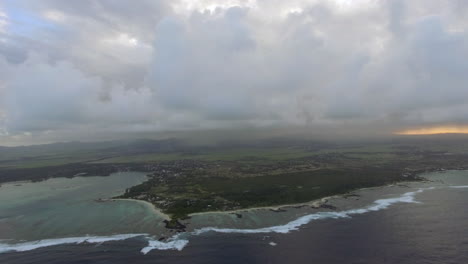 aerial shot of mauritius with low clouds and blue lagoons