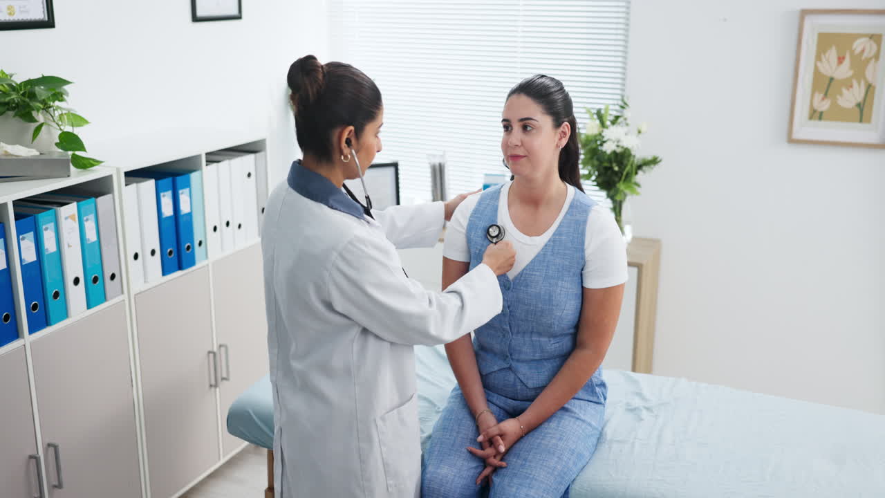 Female Doctor Examining Patient with Stethoscope in Clinic