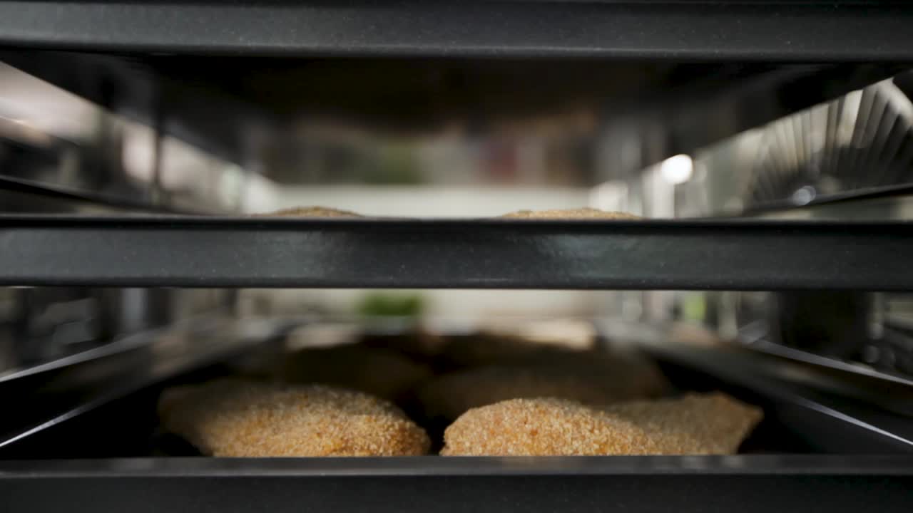 Freshly baked bread loaves on shelves in an oven, focus on the golden crust, bakery concept