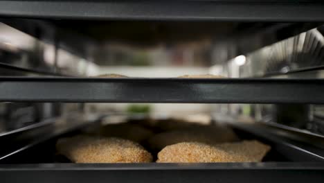 freshly baked bread loaves on shelves in an oven, focus on the golden crust, bakery concept