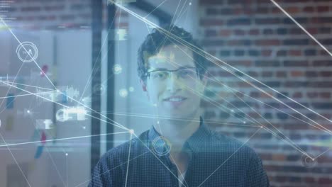 Network-of-connections-against-portrait-of-caucasian-man-smiling-at-office