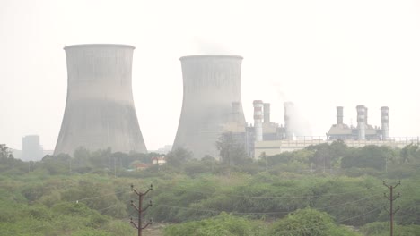 industrial thermal power plant with cooling towers and chimneys