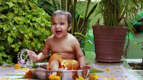 cute toddler baby boy bathing in decorated bathtub at outdoor from unique perspective