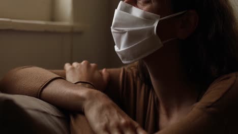 caucasian woman wearing a face mask at home