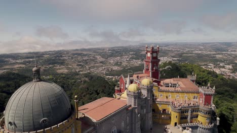 drone hovering above capturing the exterior details of pena palace in sintra portugal