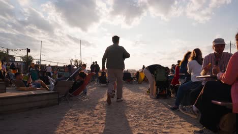 bright evening sunlight during public gathering on beach, copenhagen