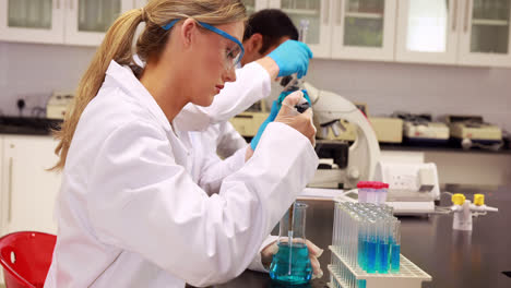 young scientist using pipette to put chemical in test tube