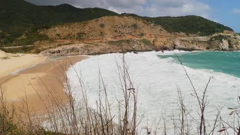 Beautiful-waves-white-waters-are-washing-up-at-the-beautiful-golden-beach-in-Koh-Samui-island,-mountains-on-the-horizon