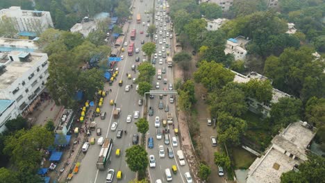 aerial drone shot capturing the morning rush on a delhi flyover, with a mix of private and public vehicles moving in sync.