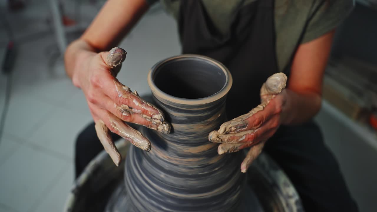 Woman Shaping a Clay Vase on a Pottery Wheel