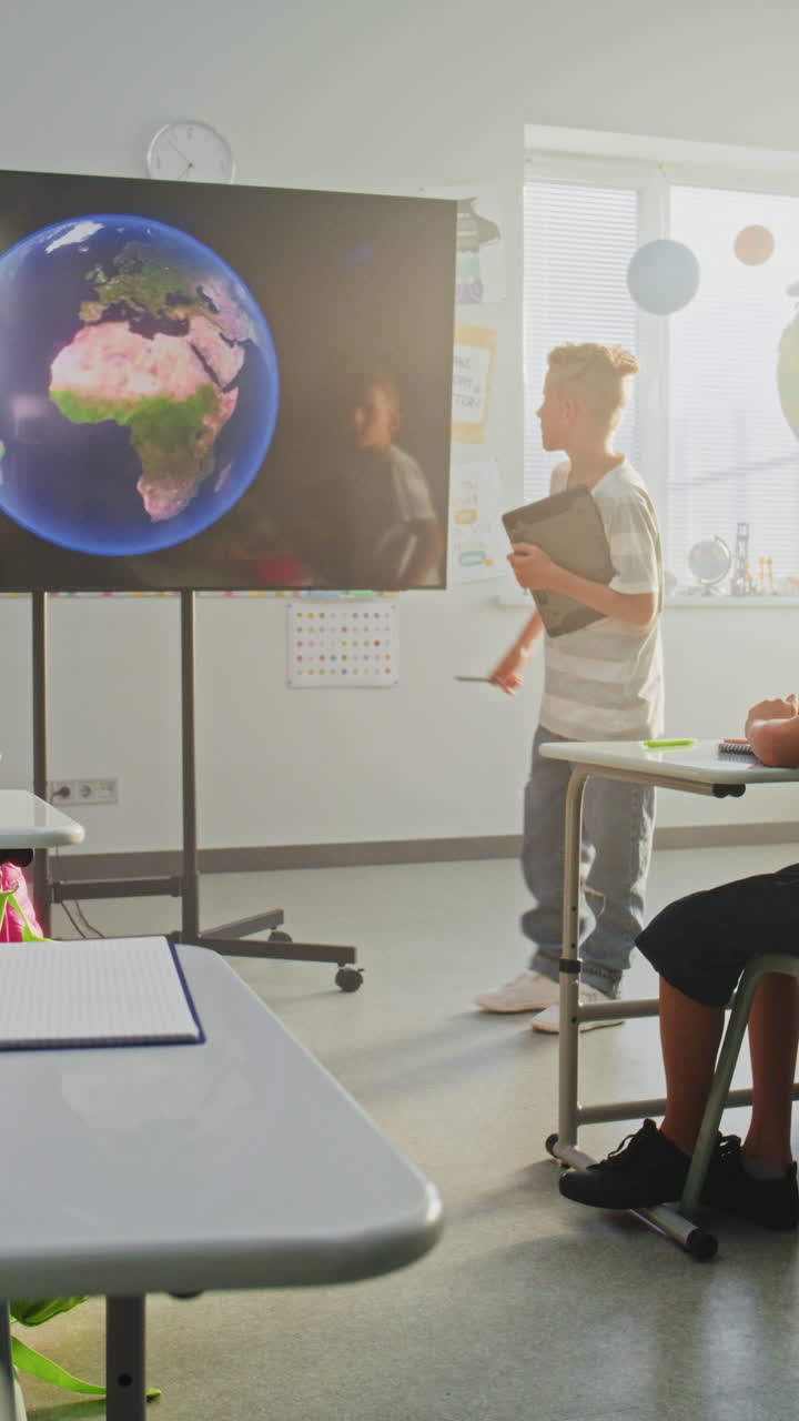 Elementary School Boy Giving Presentation About Solar System and Planets Using Digital Screen