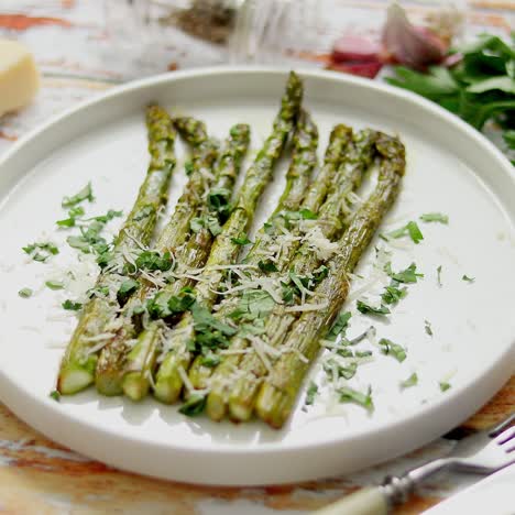 delicious roasted asparagus served on white ceramic plate  with parmesan cheese  parsley and lemon