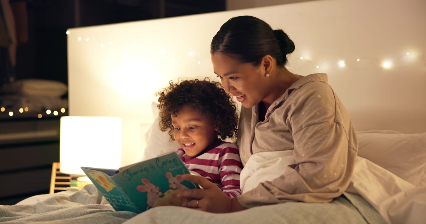 Mother Reading Bedtime Story to Young Child in Bedroom