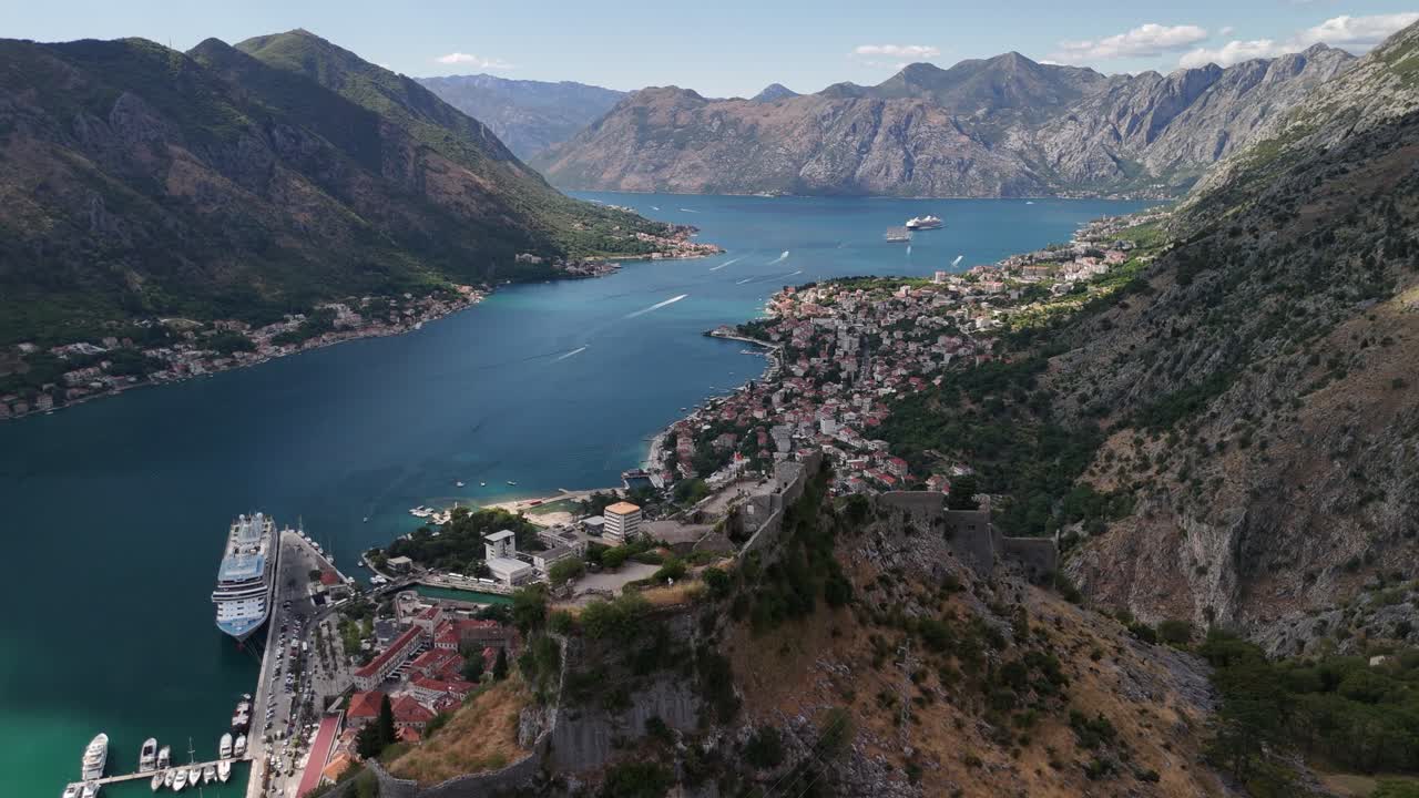 Aerial pulls out from mountain fort ruins of San Giovanni above Kotor