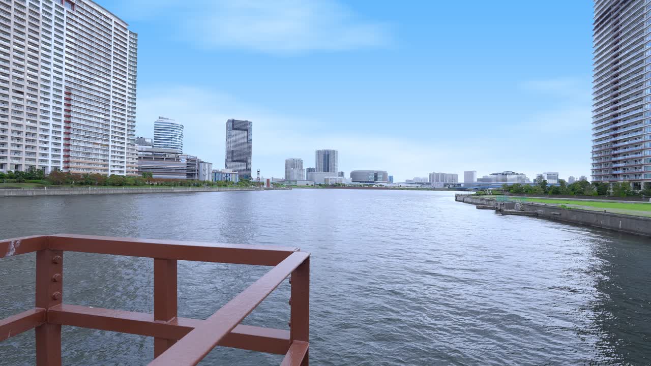 A peaceful wide shot of the Tokyo Bay area and distant cityscape, viewed from the former Harumi Railway Bridge