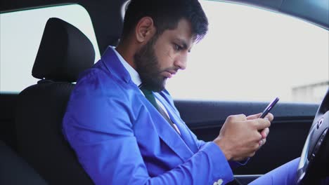 businessman texting in a car