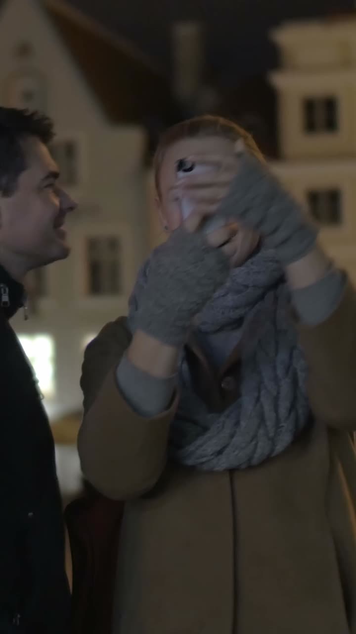 People taking a selfie at night