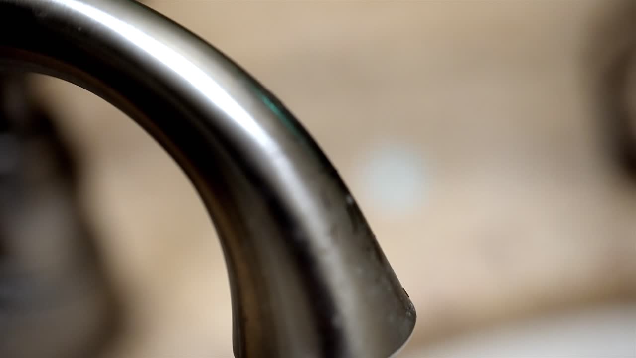A close-up shot of water flowing out from a bathroom sink, creating a refreshing flow.