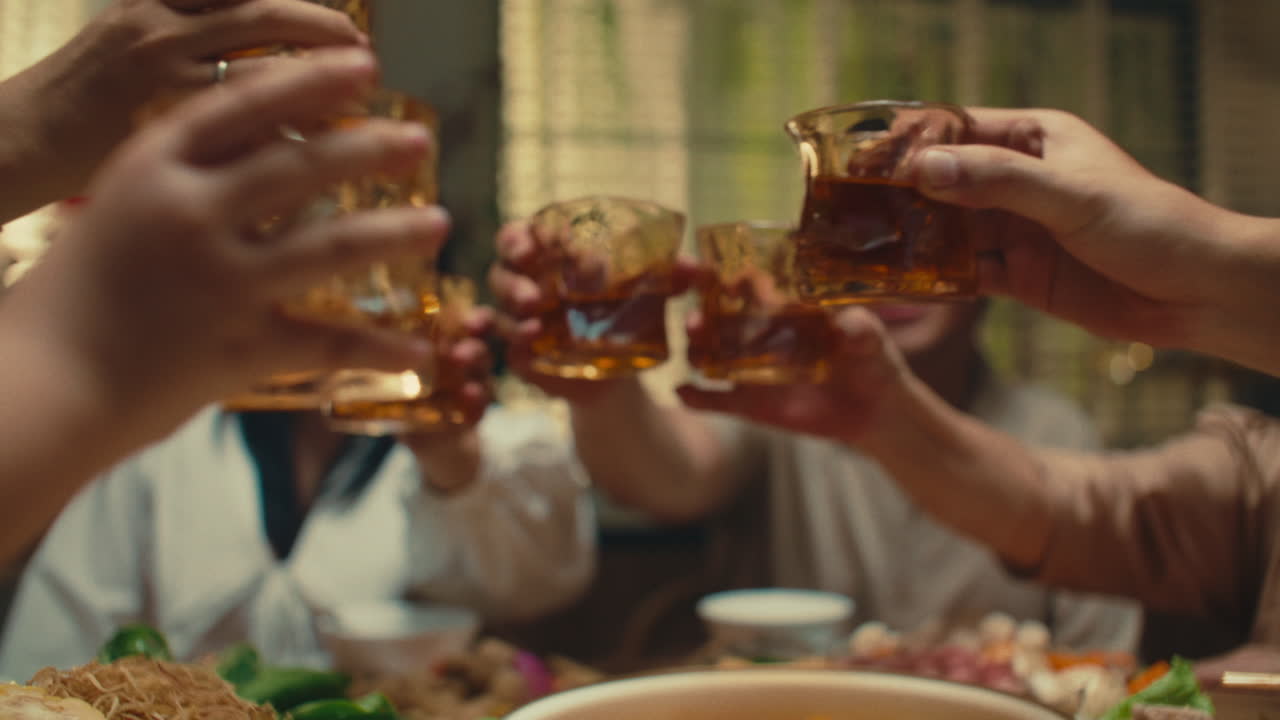 Cheers with family around dinner table celebrating togetherness and happiness