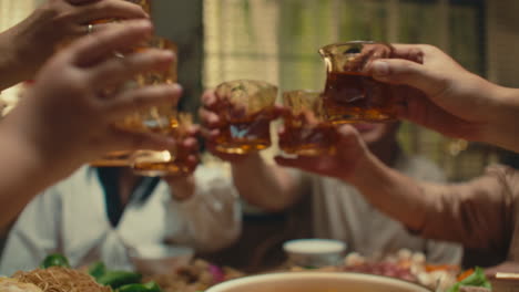 cheers with family around dinner table celebrating togetherness and happiness
