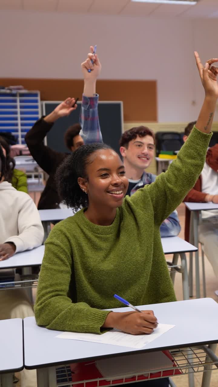 Engaged Young Woman Raises Hand to Ask Question in Classroom