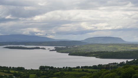 time lapse of nature landscape with hills and lake in the distance on a cloudy day in ireland