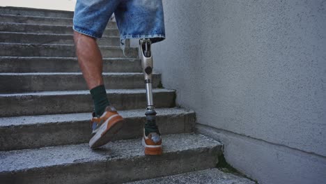person with prosthetic leg walking up stairs