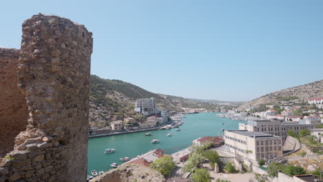 panoramic view of a coastal city with a fortress