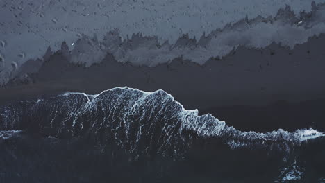 dark volcanic beach with waves