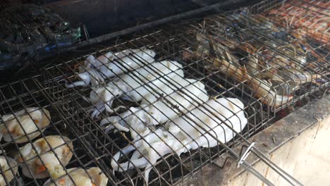 scallop cuttlefish squid shrimp and pawn being grilled on hot charcoal