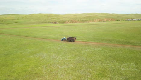 Tractor-With-Trailer-Driving-Through-Meadows-In-Kazakhstan