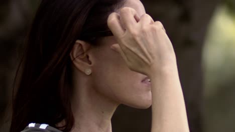 she turns away, sunlight glinting off her sleek sunglasses