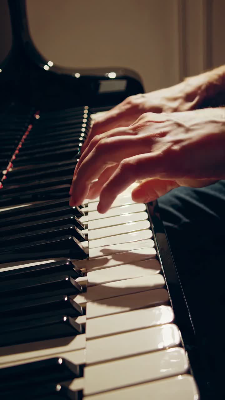 Close-up video of hands playing a piano, capturing the elegance and emotion of music
