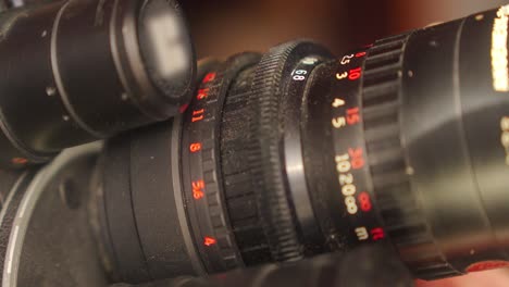 detail on the lens scale of a film camera while the zoom wheel is turning