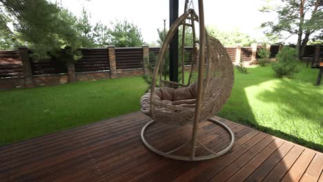 outdoor hanging egg chair on a wooden deck