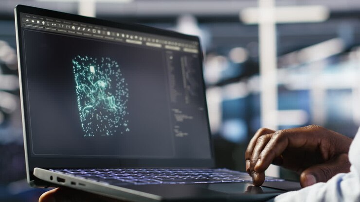 Close up of data center admin using machine learning algorithms on laptop