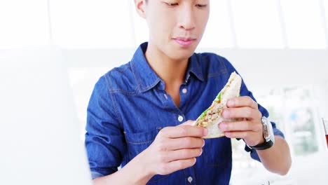 man eating sandwich with hands