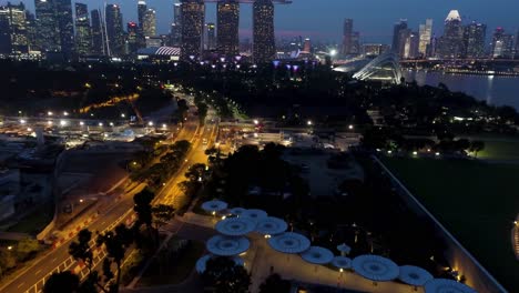 nighttime aerial view of singapore's marina bay and gardens by the bay
