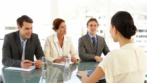 Businesswoman-being-interviewed-by-panel-and-being-offered-the-job