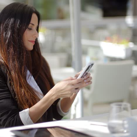 Businesswoman-checking-her-mobile-phone